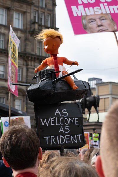 Photo of scary donald trump doll sitting astride a apier mache trident submarine.Picture